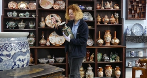 Mary Chilcott looking at Asian vase from Damien Parsons Collection